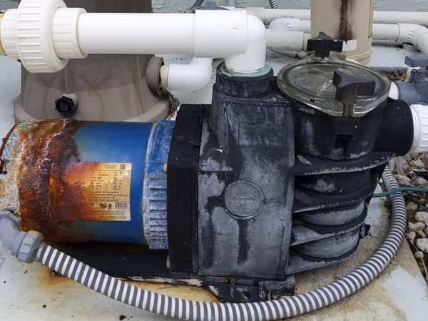Clearly Dependable technician repairing a Pentair pool pump in Stuart FL